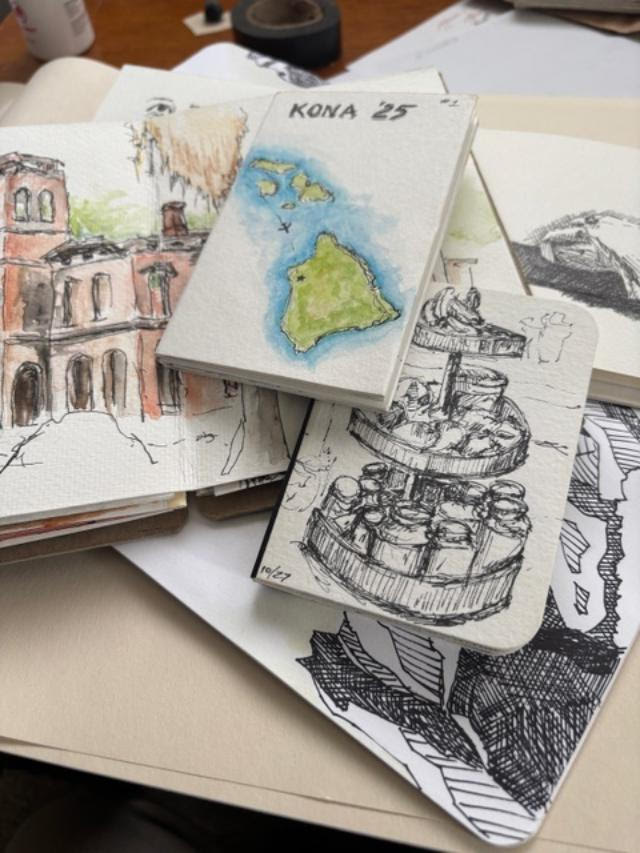 sketchbooks laid out on table